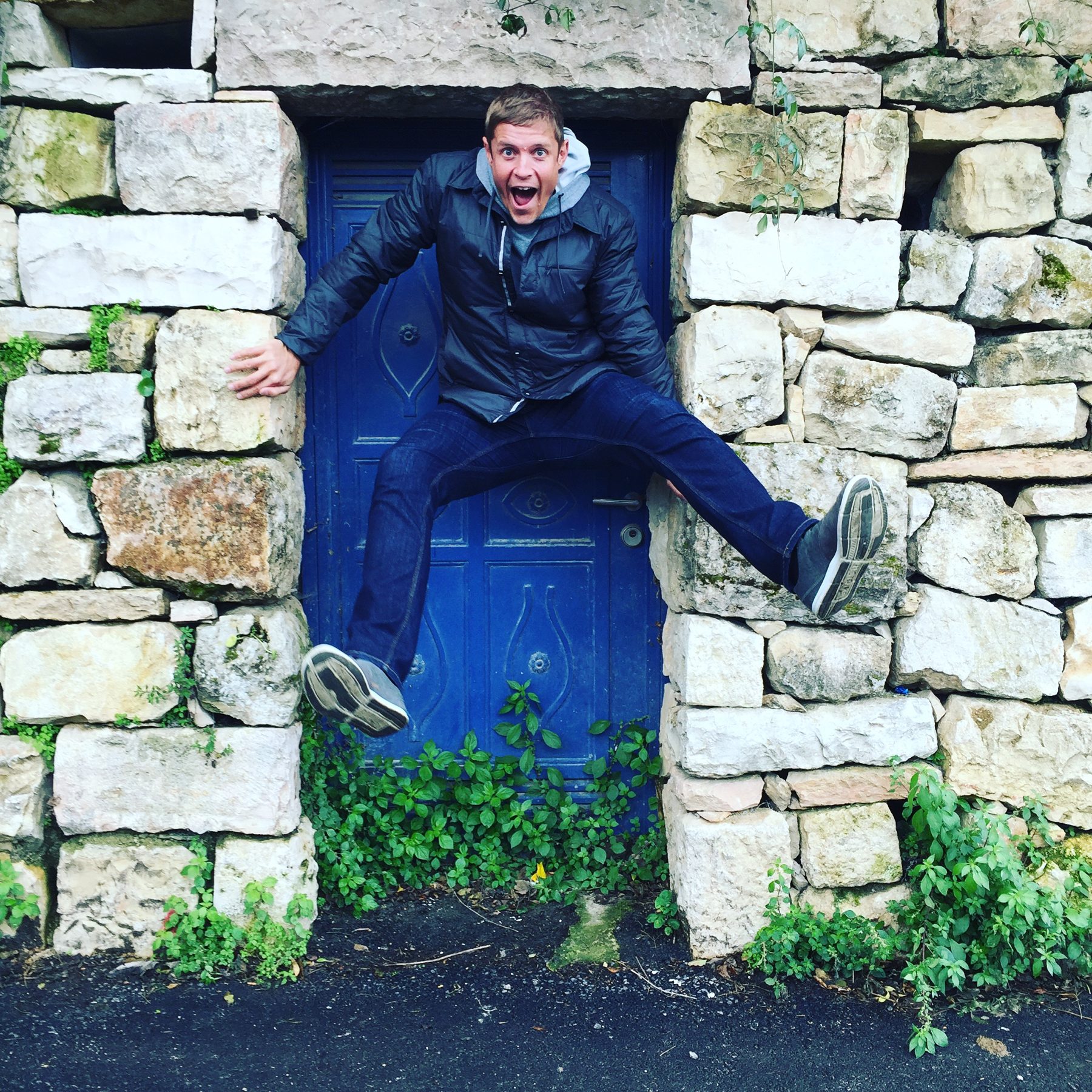 Dai Manuel braced in a stone doorway, feet on either side of the frame