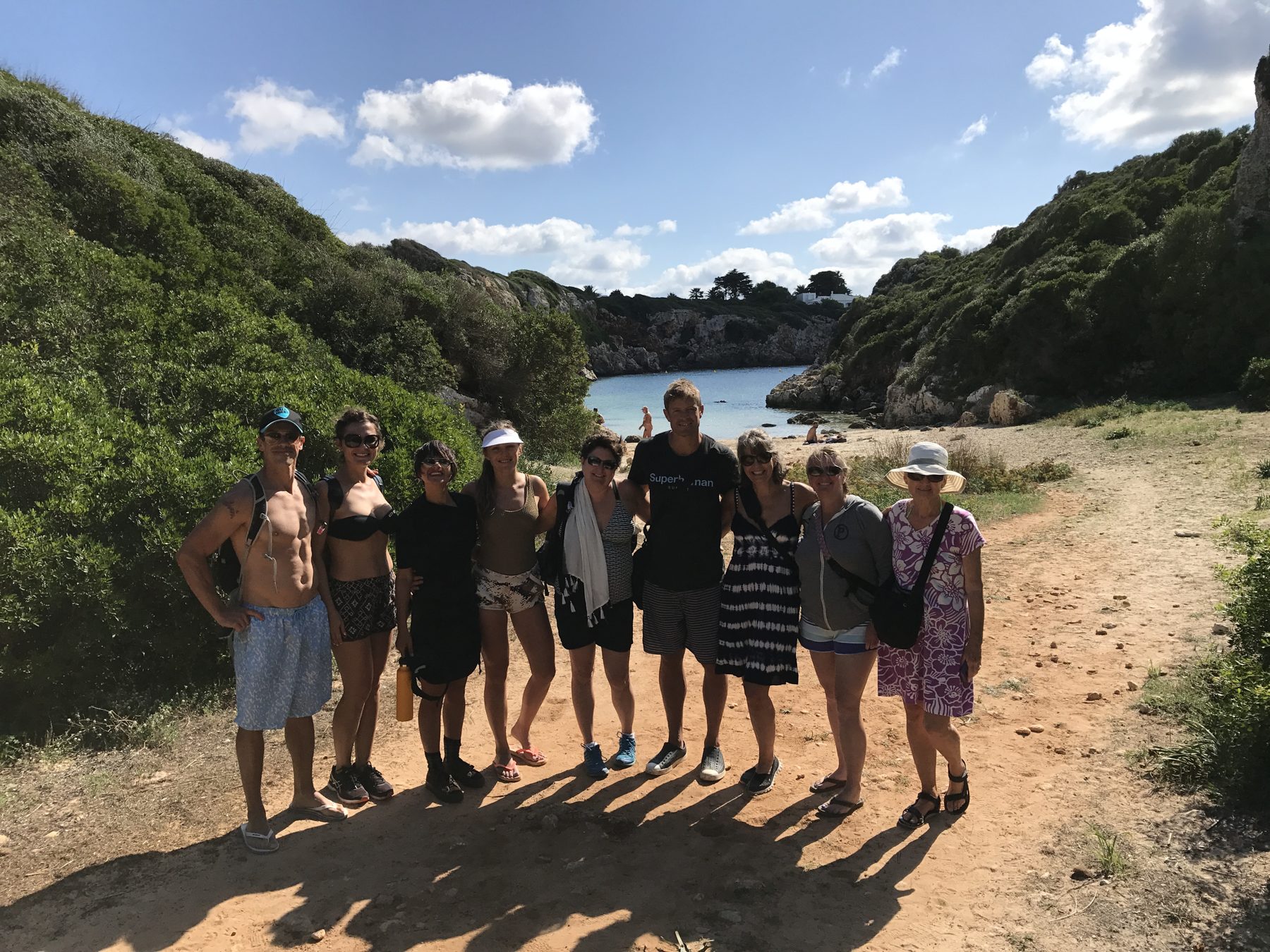 A group standing together on a coastal hiking trail