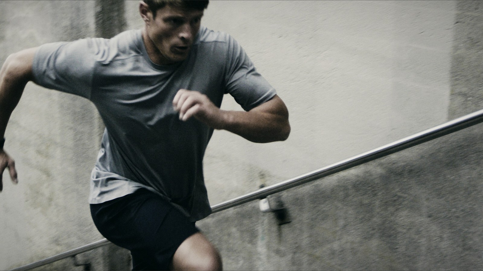 Dai Manuel running up a flight of concrete stairs