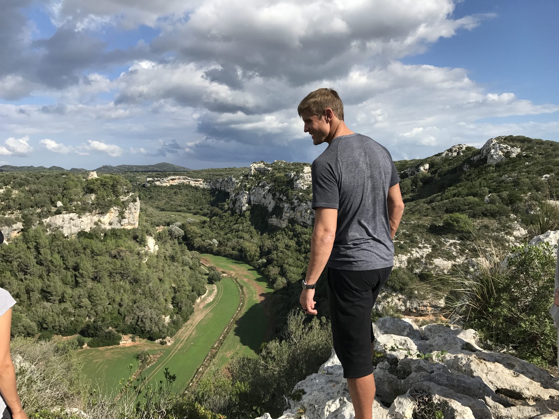 Dai Manuel standing on a mountain ridge looking across the landscape