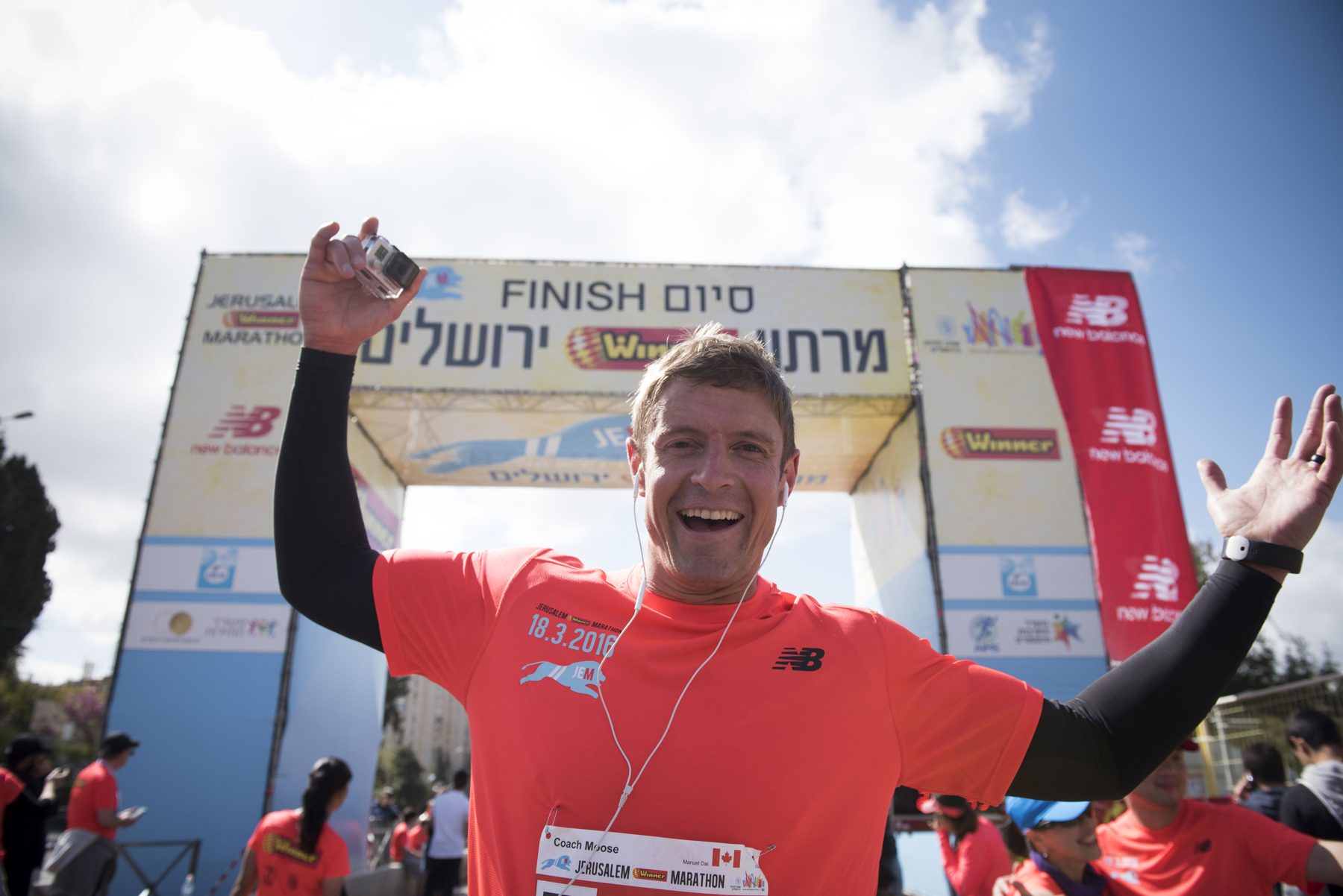 Dai Manuel crossing a race finish line with his arms up