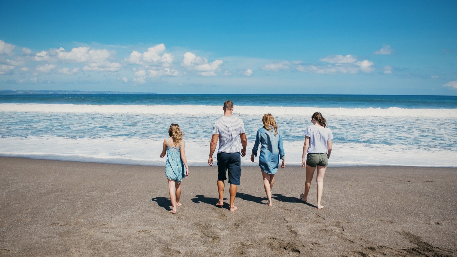 Dai Manuel walking down to the surf with his family
